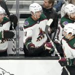 Arizona Coyotes center Nick Schmaltz (8) is greeted by teammates after he scored a goal against the Seattle Kraken during the second period of an NHL hockey game Wednesday, Feb. 9, 2022, in Seattle. (AP Photo/Ted S. Warren)