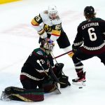 Arizona Coyotes goaltender Scott Wedgewood, bottom left, makes a save on a shot by Vegas Golden Knights right wing Evgenii Dadonov (63) as Coyotes defenseman Jakob Chychrun (6) arrives to apply pressure during the first period of an NHL hockey game Friday, Feb. 25, 2022, in Glendale, Ariz. (AP Photo/Ross D. Franklin)