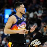 
              Phoenix Suns guard Devin Booker (1) motions to the Brooklyn Nets bench after making a three pointer during the first half of an NBA basketball game, Tuesday, Feb. 1, 2022, in Phoenix. (AP Photo/Matt York)
            