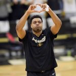 Colorado senior forward Evan Battey makes a heart with his hands to acknowledge fans as he prepares to take part in his final home regular-season NCAA college basketball game before facing Arizona, Saturday, Feb. 26 2022, in Boulder, Colo. (AP Photo/David Zalubowski)