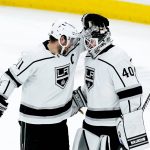 Los Angeles Kings center Anze Kopitar (11) congratulates goaltender Cal Petersen (40) as time expires in the third period of an NHL hockey game against the Arizona Coyotes, Saturday, Feb. 19, 2022, in Glendale, Ariz. (AP Photo/Ross D. Franklin)