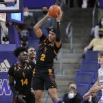 Arizona State's Jalen Graham grabs a rebound next to Enoch Boakye (14) and Washington's Cole Bajema (22) during the first half of an NCAA college basketball game Thursday, Feb. 10, 2022, in Seattle. (AP Photo/John Froschauer)