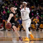 USC guard Drew Peterson (13) is pressured by Arizona State guard Luther Muhammad (1) during the first half of an NCAA college basketball game, Thursday, Feb. 3, 2022, in Phoenix. (AP Photo/Matt York)