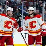 
              Calgary Flames defenseman Christopher Tanev, right, goes to celebrate his goal against the Arizona Coyotes with center Blake Coleman (20) during the second period of an NHL hockey game Wednesday, Feb. 2, 2022, in Glendale, Ariz. (AP Photo/Ross D. Franklin)
            