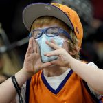 A young Phoenix Suns fan cheers during the second half of an NBA basketball game against the New Orleans Pelicans, Friday, Feb. 25, 2022, in Phoenix. (AP Photo/Matt York)