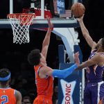 Phoenix Suns forward Mikal Bridges (25) shoots in front of Oklahoma City Thunder forward Isaiah Roby (22) in the first half of an NBA basketball game Thursday, Feb. 24, 2022, in Oklahoma City. (AP Photo/Sue Ogrocki)