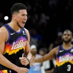 Phoenix Suns guard Devin Booker (1) celebrates a basket during the second half of an NBA basketball game against the Los Angeles Clippers, Tuesday, Feb. 15, 2022, in Phoenix. The Suns won 103-96. (AP Photo/Matt York)