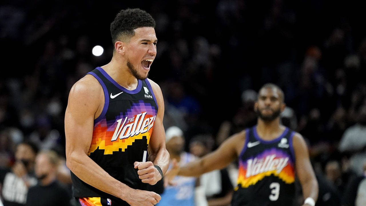 Phoenix Suns guard Devin Booker (1) celebrates a basket during the second half of an NBA basketball...