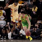 
              Oregon guard Will Richardson (0) moves the ball up court as Arizona State forward Alonzo Gaffney (32) defends during the first half of an NCAA college basketball game, Thursday, Feb. 17, 2022, in Tempe, Ariz. (AP Photo/Matt York)
            