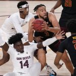 Southern California forward Isaiah Mobley (3) looks to shoot as Arizona State center Enoch Boakye (14) and forward Alonzo Gaffney, left, defend during the second half of an NCAA college basketball game, Thursday, Feb. 3, 2022, in Phoenix. (AP Photo/Matt York)