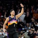 Phoenix Suns guard Devin Booker (1) motions after making a three pointer against the Brooklyn Nets during the second half of an NBA basketball game, Tuesday, Feb. 1, 2022, in Phoenix. The Suns defeated the Nets 121-111. (AP Photo/Matt York)