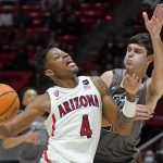 Arizona guard Dalen Terry (4) goes to the basket as Utah guard Lazar Stefanovic defends during the first half of an NCAA college basketball game Thursday, Feb. 24, 2022, in Salt Lake City. (AP Photo/Rick Bowmer)