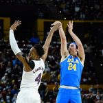 UCLA guard Jaime Jaquez Jr. (24) shoots a 3-pointer over Arizona State forward Kimani Lawrence (4) during the first half of an NCAA college basketball game Saturday, Feb. 5, 2022, in Tempe, Ariz. (AP Photo/Ross D. Franklin)