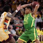 
              Oregon guard Jacob Young (42) looks to pass as Arizona State guard Jay Heath defends during the first half of an NCAA college basketball game, Thursday, Feb. 17, 2022, in Tempe, Ariz. (AP Photo/Matt York)
            