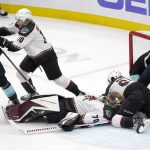 Arizona Coyotes goaltender Karel Vejmelka (70) goes down while making a stop against the Seattle Kraken during the first period of an NHL hockey game, Wednesday, Feb. 9, 2022, in Seattle. (AP Photo/Ted S. Warren)