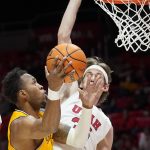 Arizona State forward Kimani Lawrence, left, goes to the basket as Utah center Branden Carlson, right, defends during the first half of an NCAA college basketball game Saturday, Feb. 26, 2022, in Salt Lake City. (AP Photo/Rick Bowmer)