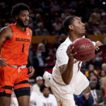 Arizona State guard Luther Muhammad passes as Oregon State forward Maurice Calloo, left, looks on during the first half of an NCAA college basketball game, Saturday, Feb. 19, 2022, in Tempe, Ariz. (AP Photo/Matt York)