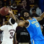 Arizona State guard Marreon Jackson (3) grabs a rebound away from UCLA center Myles Johnson (15) during the second half of an NCAA college basketball game Saturday, Feb. 5, 2022, in Tempe, Ariz. Arizona State won in three overtimes, 87-84. (AP Photo/Ross D. Franklin)