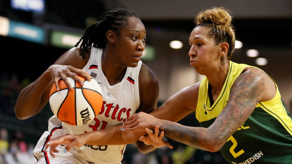 Tina Charles #31 of the Washington Mystics dribbles against Mercedes Russell #2 of the Seattle Stor...