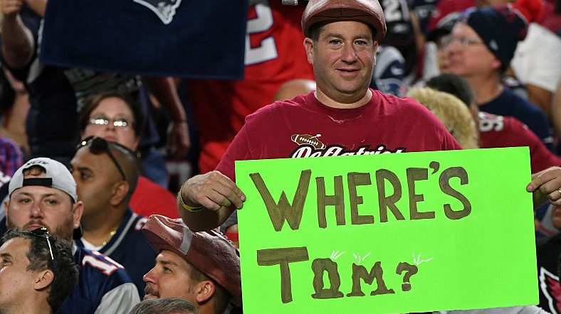 A fan holds a sign referencing the four-game suspension of quarterback Tom Brady of the New England...