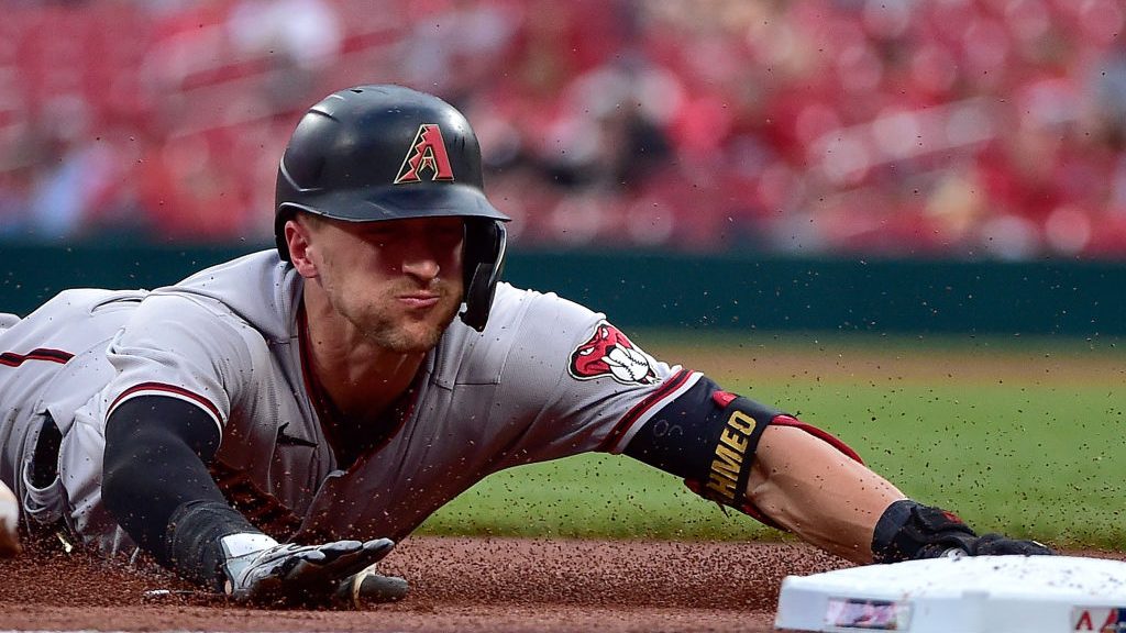 Nick Ahmed #13 of the Arizona Diamondbacks slides into third base for a triple during the second in...