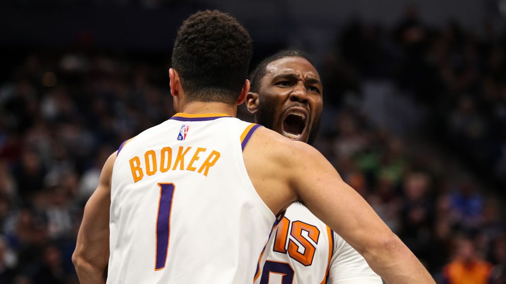 Jae Crowder #99 celebrates a dunk by Devin Booker #1 of the Phoenix Suns against the Minnesota Timb...
