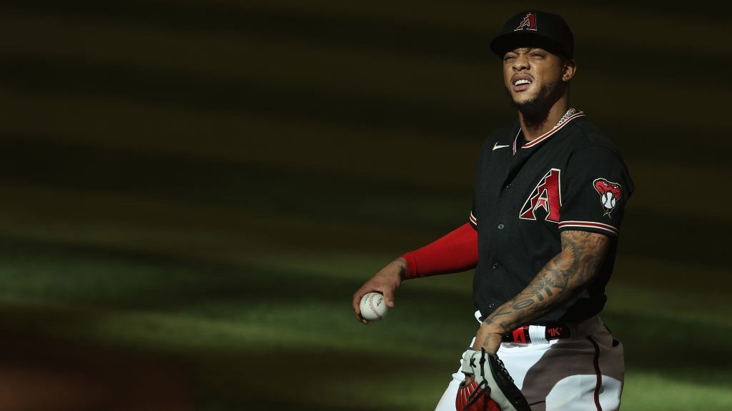 Ketel Marte #4 of the Arizona Diamondbacks throws a ball up to the fans during the ninth inning of ...