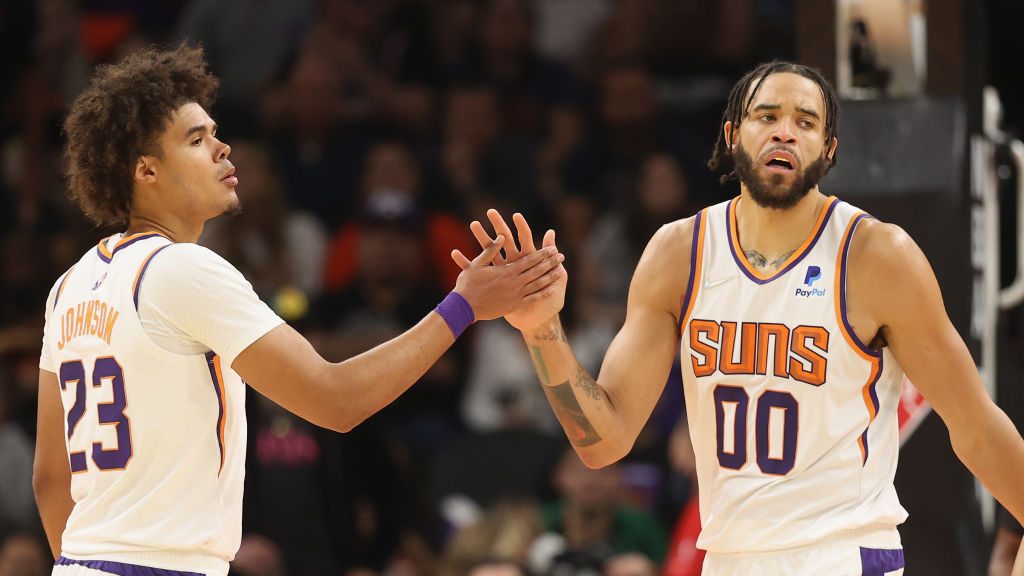 JaVale McGee #00 of the Phoenix Suns high fives Cameron Johnson #23 after scoring and drawing a fou...