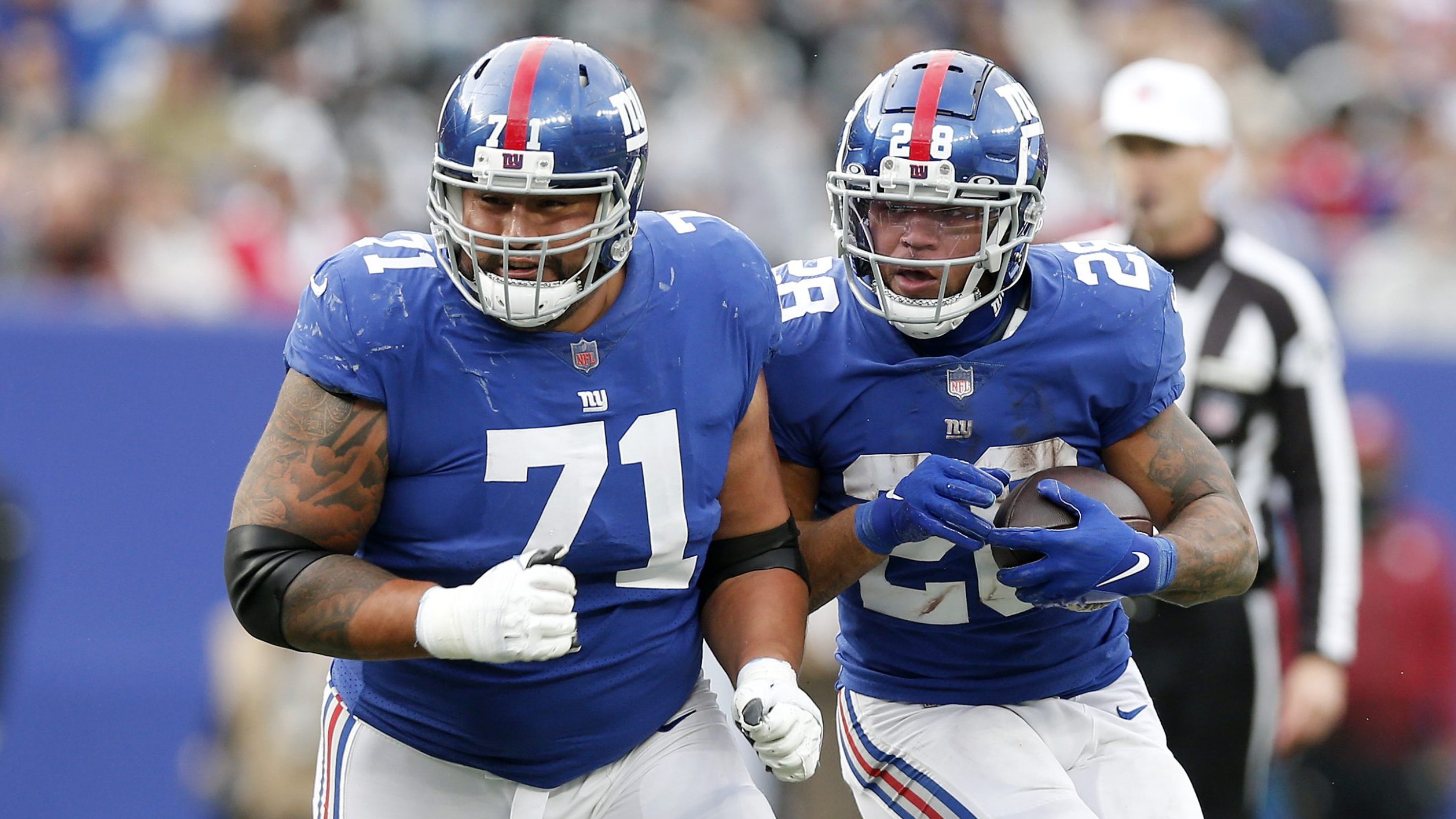 Will Hernandez #71 and Devontae Booker #28 of the New York Giants in action against the Las Vegas R...