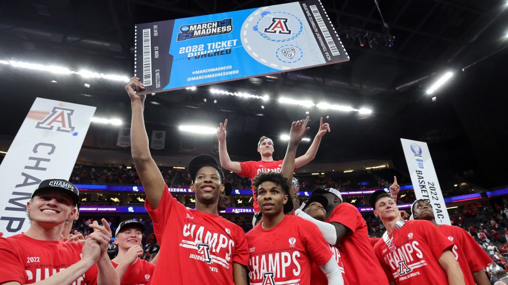 Dalen Terry #4 of the Arizona Wildcats holds up a ceremonial NCAA tournament ticket as the team cel...