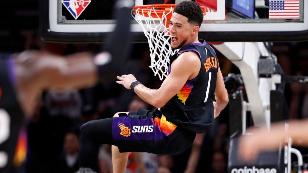 Devin Booker #1 of the Phoenix Suns reacts after dunking the ball during the first half against the...