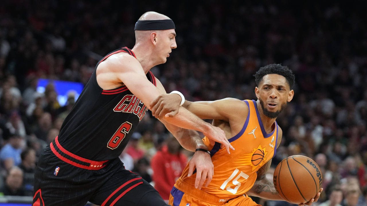 Phoenix Suns guard Cameron Payne (15) shields the ball from Chicago Bulls guard Alex Caruso during ...