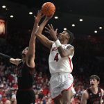 Arizona guard Dalen Terry (4) shoots over Stanford forward Spencer Jones during the second half of an NCAA college basketball game Thursday, March 3, 2022, in Tucson, Ariz. Arizona won 81-69. (AP Photo/Rick Scuteri)