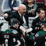 Arizona Coyotes head coach André Tourigny, top, shouts at officials as Nick Ritchie (12), Clayton Keller (9) and Lawson Crouse (67) listen during the third period of an NHL hockey game against the Colorado Avalanche on Thursday, March 3, 2022, in Glendale, Ariz. The Coyotes won 2-1. (AP Photo/Ross D. Franklin)