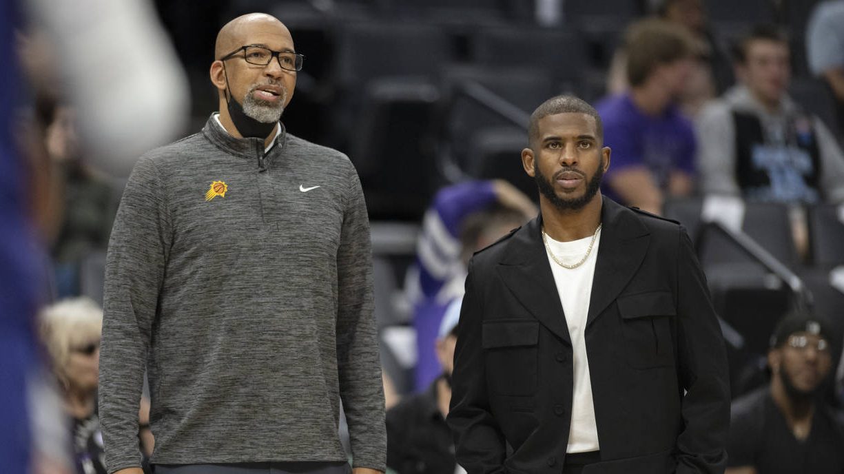 Phoenix Suns head coach Monty Williams, left and injured Suns guard Chris Paul, right, watch the ac...