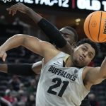 Colorado's Evan Battey (21) grabs a rebound against Oregon during the second half of an NCAA college basketball game in the quarterfinal round of the Pac-12 tournament Thursday, March 10, 2022, in Las Vegas. (AP Photo/John Locher)