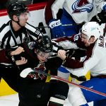 Arizona Coyotes defenseman Dysin Mayo (61) fights Colorado Avalanche center Nathan MacKinnon (29) as linesman Libor Suchanek (60) tries to break the two apart during the third period of an NHL hockey game Thursday, March 3, 2022, in Glendale, Ariz. The Coyotes won 2-1. (AP Photo/Ross D. Franklin)