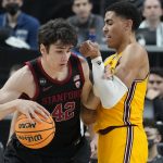 Stanford's Maxime Raynaud (42) drives into Arizona State's Jalen Graham (2) during the first half of an NCAA college basketball game in the first round of the Pac-12 tournament Wednesday, March 9, 2022, in Las Vegas. (AP Photo/John Locher)