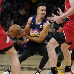 Phoenix Suns guard Landry Shamet, center, looks to pass against the Portland Trail Blazers during the second half of an NBA basketball game, Wednesday, March 2, 2022, in Phoenix. (AP Photo/Matt York)