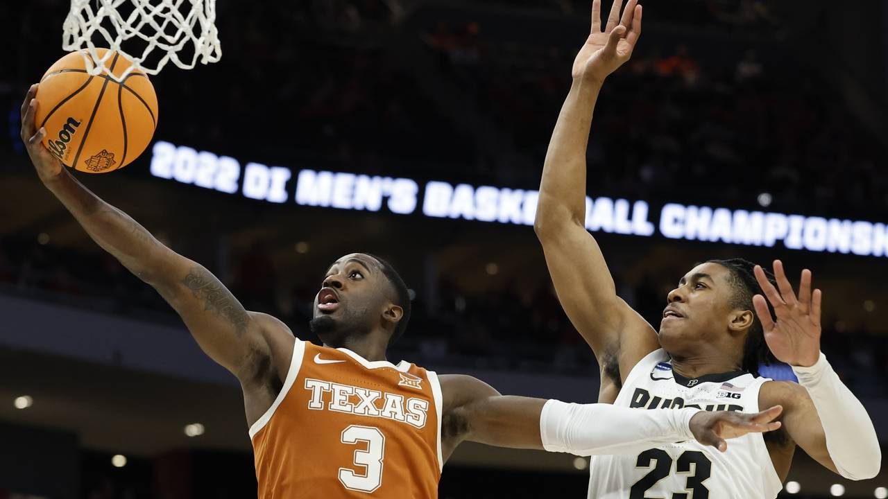 Texas's Courtney Ramey shoots past Purdue's Jaden Ivey during the first half of a second-round NCAA...