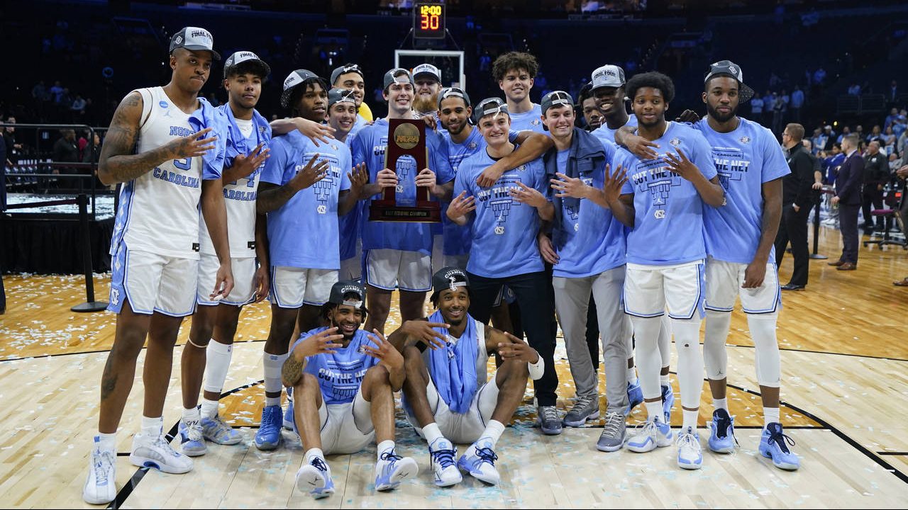 North Carolina players pose for a photo after North Carolina won a college basketball game against ...