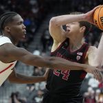 Arizona's Bennedict Mathurin (0) guards Stanford's Sam Beskind (24) during the first half of an NCAA college basketball game in the quarterfinal round of the Pac-12 tournament Thursday, March 10, 2022, in Las Vegas. (AP Photo/John Locher)
