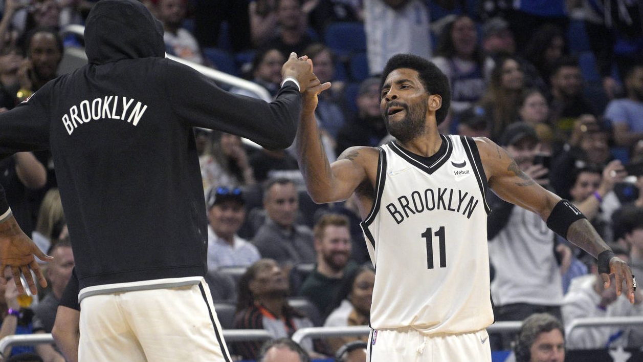 Brooklyn Nets guard Kyrie Irving (11) celebrates with forward Kevin Durant, left, after Irving scor...