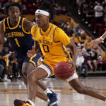 Arizona State guard DJ Horne (0) drives as California guard Joel Brown (1) defends during the second half of an NCAA college basketball game, Thursday, March 3, 2022, in Tempe, Ariz. (AP Photo/Matt York)