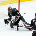 Arizona Coyotes goaltender Karel Vejmelka (70) makes a save against the Colorado Avalanche as Coyotes defenseman Jakob Chychrun (6) looks on during the first period of an NHL hockey game Thursday, March 3, 2022, in Glendale, Ariz. (AP Photo/Ross D. Franklin)