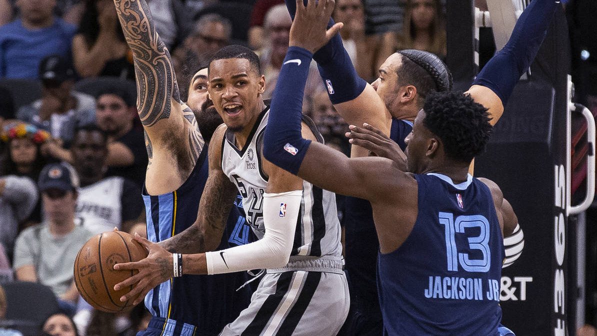San Antonio Spurs guard Dejounte Murray (5) looks for an open teammate as Memphis Grizzlies forward...