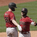 Arizona Diamondbacks' Cooper Hummel (21) celebrates with Pavin Smith (26) after hitting a two-run home run during the third inning of a spring training baseball game Sunday, March 20, 2022, in Surprise, Ariz. (AP Photo/Charlie Riedel)
