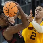 Stanford's Harrison Ingram, left, and Arizona State's Jalen Graham (2) battle for the ball during the first half of an NCAA college basketball game in the first round of the Pac-12 tournament Wednesday, March 9, 2022, in Las Vegas. (AP Photo/John Locher)