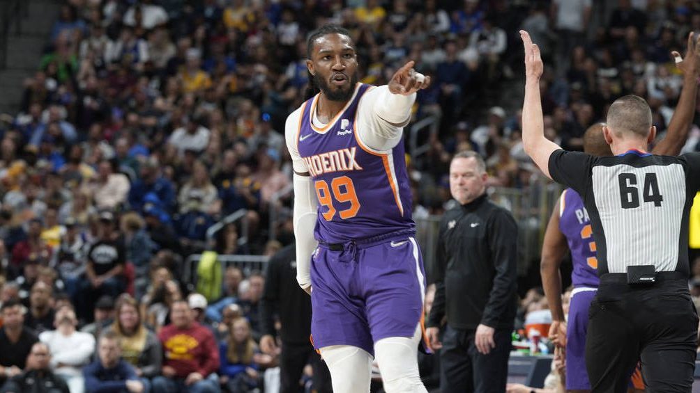 Phoenix Suns forward Jae Crowder points to the bench after hitting a 3-point shot late in the secon...