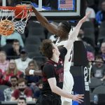 Arizona's Christian Koloko (35) dunks against Stanford's Max Murrell (10) during the first half of an NCAA college basketball game in the quarterfinal round of the Pac-12 tournament Thursday, March 10, 2022, in Las Vegas. (AP Photo/John Locher)